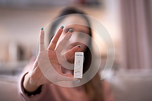 Girl holding a corona virus SARS-Cov-2 rapid antigen test