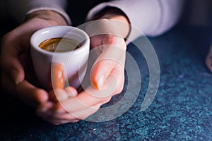 The girl is holding a cup of American coffee.