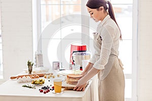 Girl holding a cutting board with cake