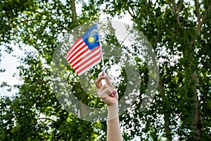 The girl holding the flag of Malaysia