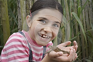Girl Holding Frog Outdoors