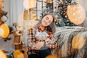 Girl holding a gift box and enjoying Christmas time