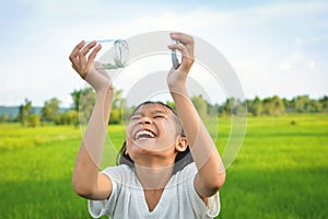 Girl holding glass jar for keeping fresh air