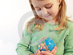 Girl holding globe