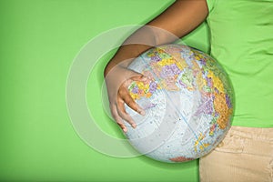 Girl holding globe.