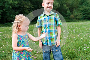 girl holding grasshopper, curiosity and education concept