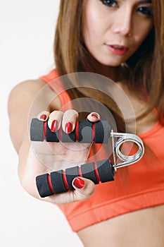 Girl holding gripper in her hand. photo