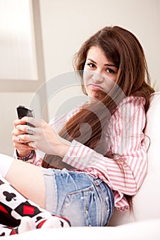 Girl holding a grouch against mobile phone