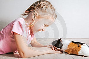 Girl holding a guinea pig in her arms