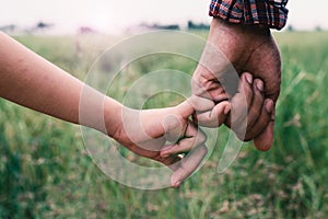 A girl holding hands with father,Vintage filters.