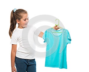 girl holding hanger with turquoise t-shirt