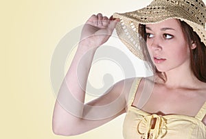 Girl holding hat brim