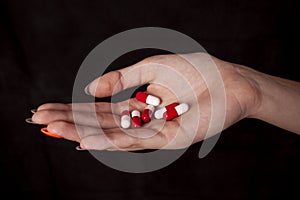 Girl holding heap of drugs in hand