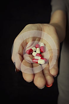 Girl holding heap of drugs in hand