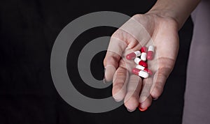 Girl holding heap of drugs in hand