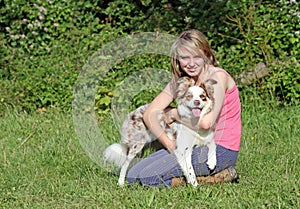 Girl holding her Border Collie dog.