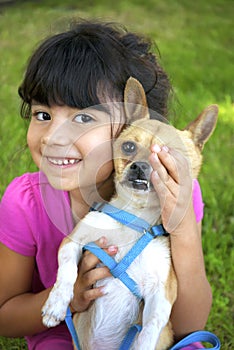 Girl holding her chihuahua