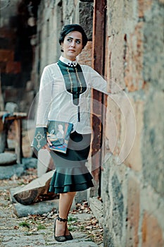 Girl holding her creative bag and waiting for someone in nature