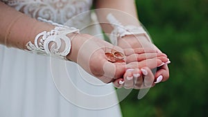 Girl holding in his hands two wedding rings.