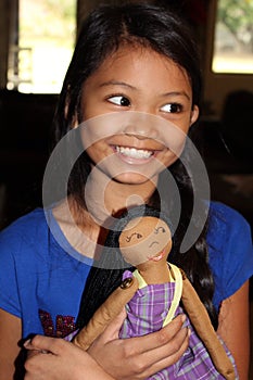 Girl holding homemade doll