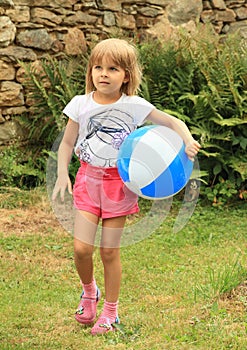 Girl holding inflating ball