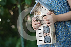 Girl holding insect hotel