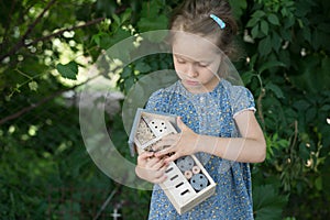 Girl holding insect hotel
