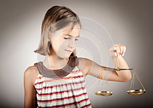 Girl holding justice scale