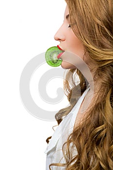 Girl holding a kiwi slice with the lips