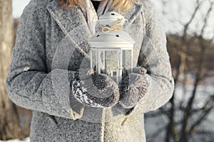 Girl holding lantern with a burning candle inside