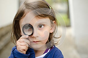 Girl holding magnifying glass