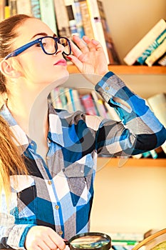 Girl holding magnifying glass