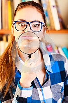 Girl holding magnifying glass