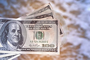 Girl holding money bill of 300 dollars on background of sea ocean