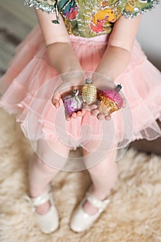 Girl holding old Christmas toys