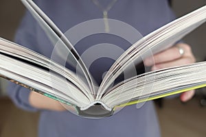 Girl holding an open book in front of her