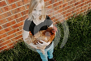 Girl holding a pet chicken