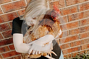 Girl holding a pet chicken