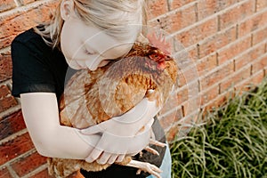 Girl holding a pet chicken