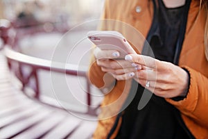 Girl holding phone in hands. Close up picture