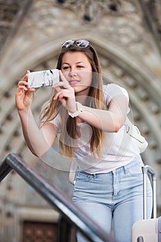 Girl holding phone and photographing