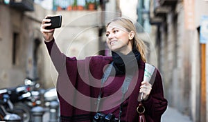 Girl holding phone and photographing