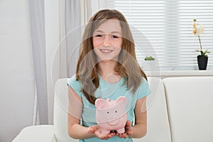 Girl Holding Piggy Bank