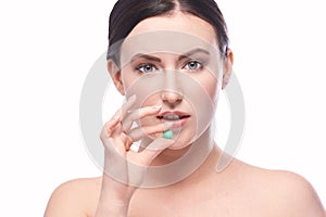 Girl holding a pill. Vitamins concept. Beautiful portrait