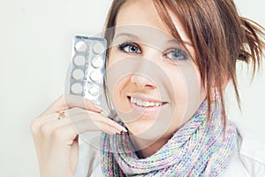 A girl holding a pills