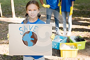 Girl holding placard with globe and