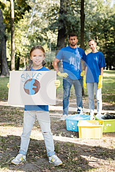 Girl holding placard with globe and