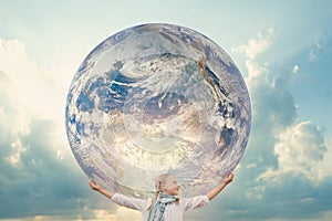 Girl holding the Planet Earth. Future Concept. Elements of this image furnished by NASA