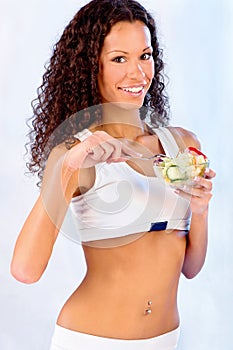 Girl holding plate with salad