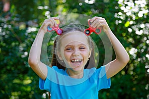 girl holding popular fidget spinner toy